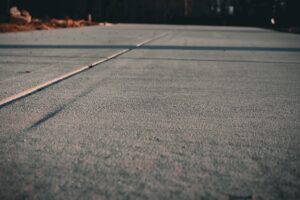 Performing concrete preparation for residential concrete driveway.