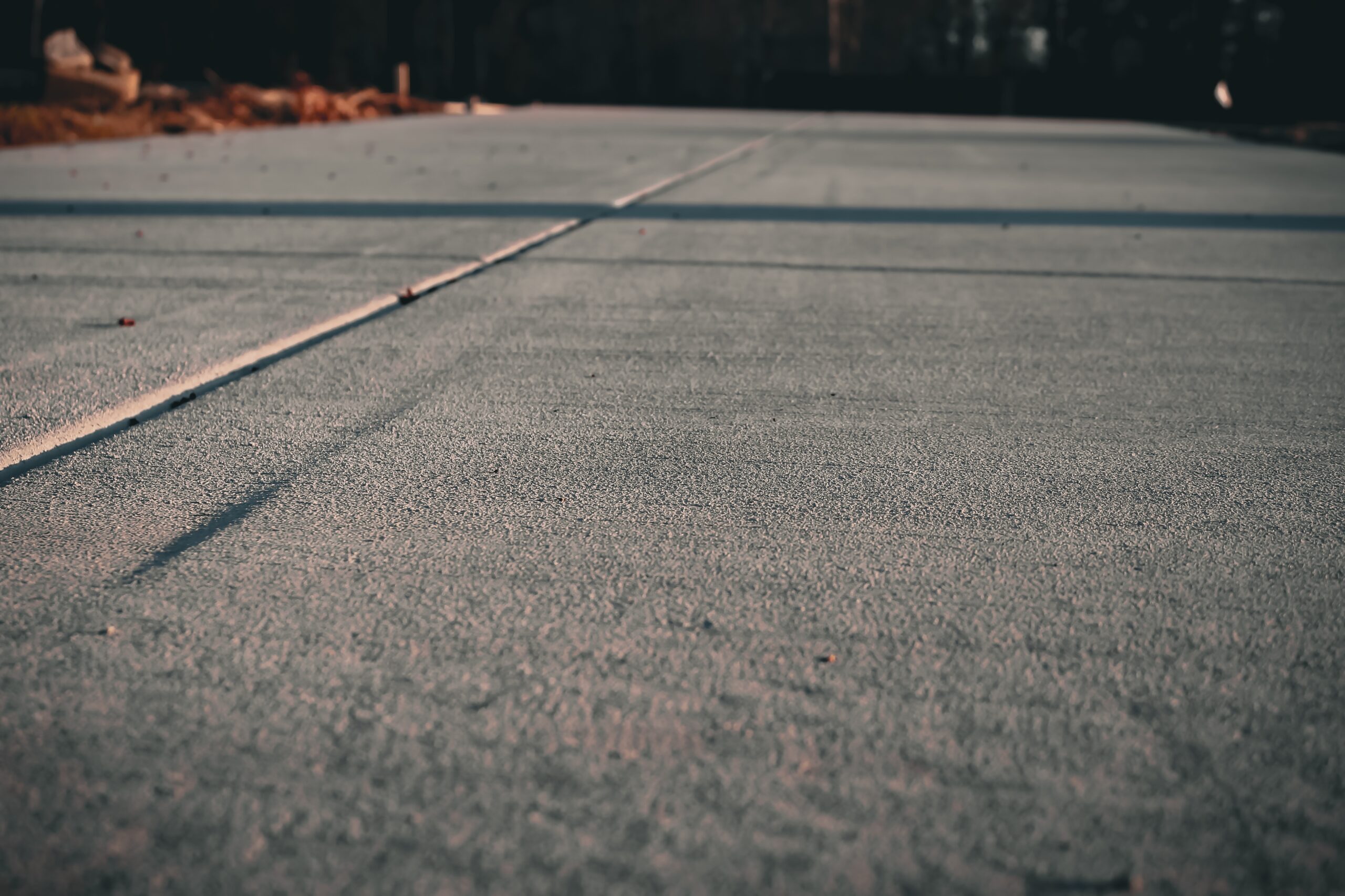 Performing concrete preparation for residential concrete driveway.