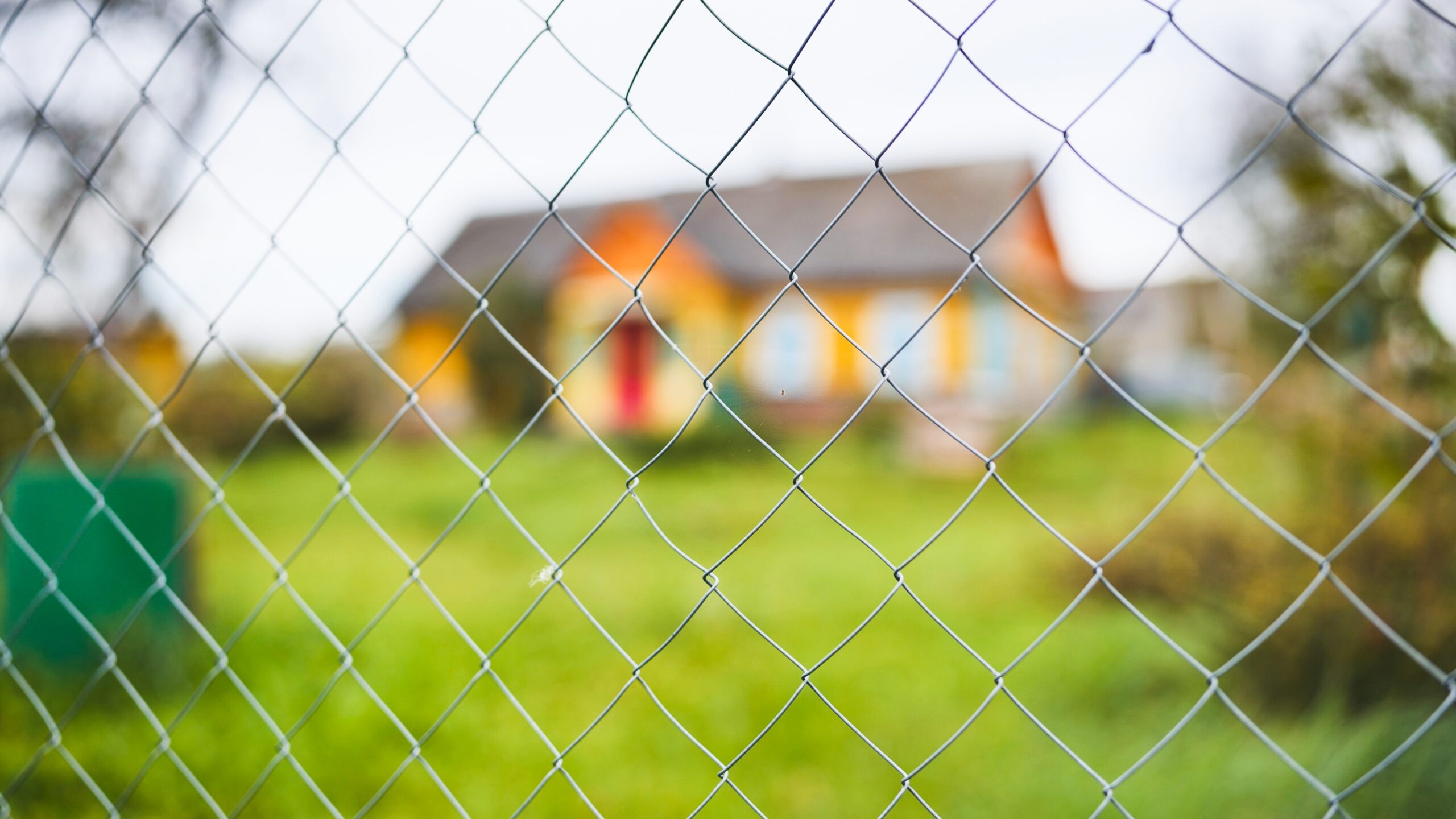 Temporary fencing installed around residential home for security during renovation.