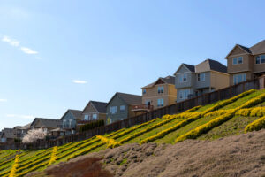 Fence on a slope following uneven terrain in a San Antonio yard with changing grade and elevation.