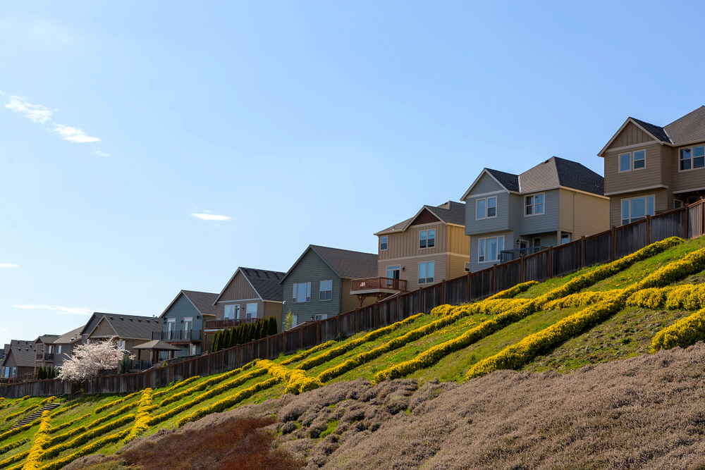 Fence on a slope following uneven terrain in a San Antonio yard with changing grade and elevation.
